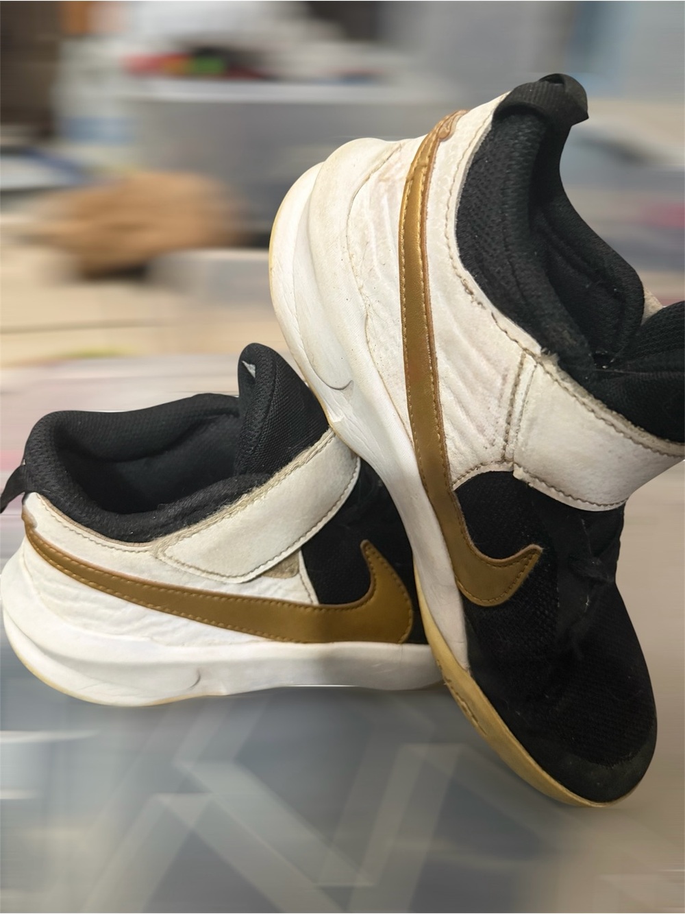 Nike Team Hustle D10 Kids Black, White & Gold Athletic Sneakers